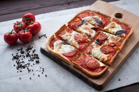 rustic italian pizza with mozzarella, cheese and basil leaves. vegetarian foodの写真素材