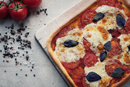 rustic italian pizza with mozzarella, cheese and basil leaves. vegetarian foodの写真素材