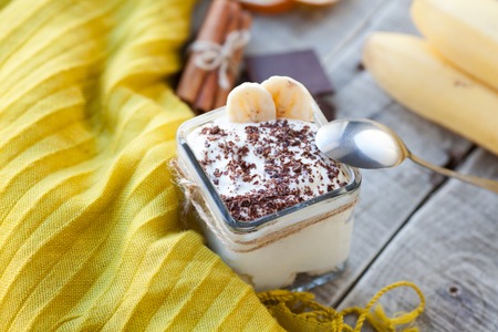 Creamy pudding with banana, chocolate and cinnamon for breakfast.の写真素材
