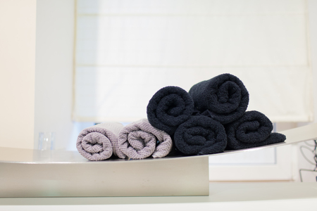 Pink and black rolled-up towels in the Spa.の写真素材
