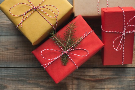 Christmas background with gift boxes on wooden background. Top view. Beautifully packaged...
