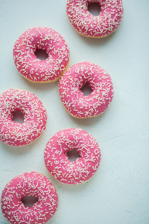 Donut. Sweet icing sugar food. Dessert colorful snack. Glazed sprinkles. Treat from delicious pastry breakfast. Bakery cake. Doughnut with frosting. Baked unhealthy round. Top view.の写真素材
