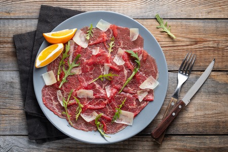 Marbled beef carpaccio with arugula and parmesan.の写真素材