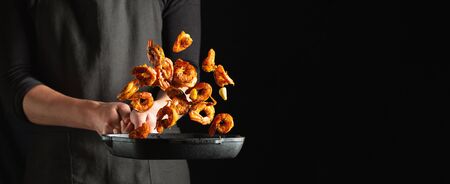 Professional chef prepares shrimps or langoustines with spices. Cooking mediterranean seafood, healthy vegetarian food on a dark background. With copy space for text.の写真素材
