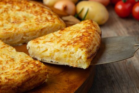 Spanish omelette with potatoes and onion, typical Spanish cuisine. Tortilla espanola. Rustic dark backgroundの写真素材