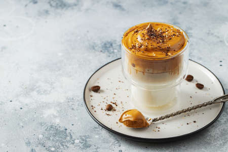 Dalgona coffee. Iced fluffy creamy whipped trend drink with coffee foam and milk.の写真素材