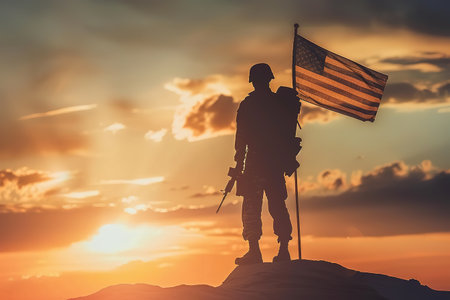 Silhouette of soldier with USA flag against the sunset. Greeting card for Veterans Day, Memorial Day, Independence Dayの素材
