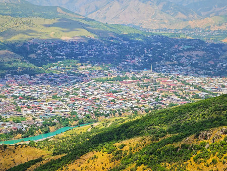 An expansive panoramic view of Chorvoq urban-type settlement in Bostanliq District, Tashkent Region, Uzbekistan, captured from the foothills of Mount Kungurbuka.の写真素材