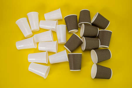plastic and eco mugs on a yellow backgroundの写真素材