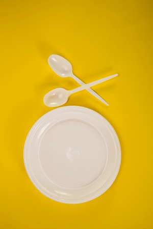 plastic plate with fillet and spoon on a yellow background,の写真素材