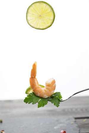 shrimp on a fork, place for your text, isolated on white backgroundの写真素材