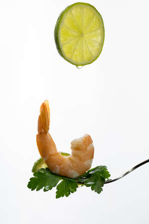 shrimp on a fork, place for your text, isolated on white backgroundの写真素材