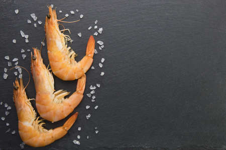 Shrimp with lime on a stone plate, sprinkledの写真素材