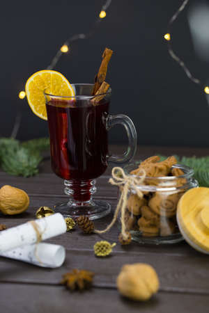 mug of warm wine with orange, jar of cookies, musical notes decor.の写真素材