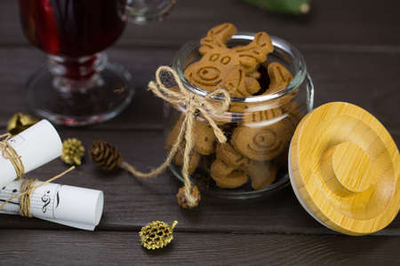 mug of warm wine with orange, jar of cookies, musical notes decor.の写真素材