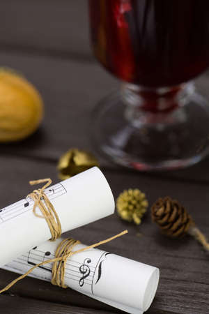 mug of warm wine with orange, jar of cookies, musical notes decor.の写真素材