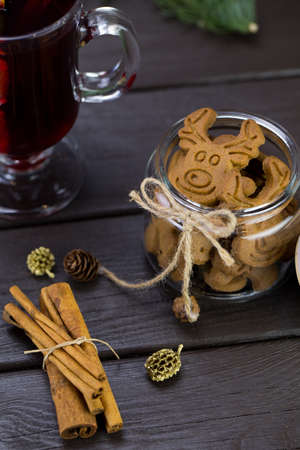 mug of warm wine with orange, jar of cookies.の写真素材