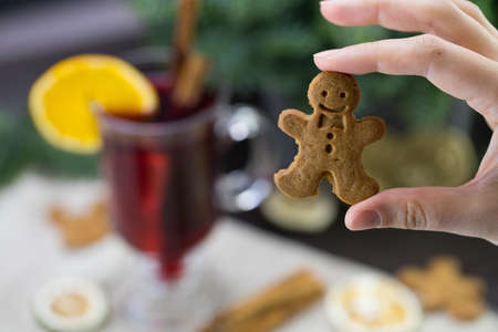 man cookie, on the background of a mug with warm Christmas wine.の写真素材