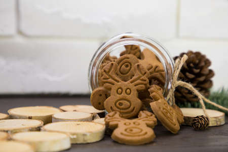 Jar with scattered cookies on a brick wall background.の写真素材