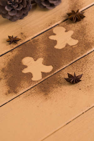 Christmas cookies around cinnamon, on a wooden board.の写真素材