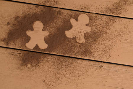 Christmas cookies around cinnamon, on a wooden board.の写真素材