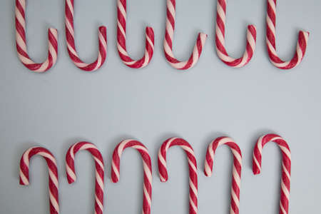 red and white christmas candy cane, on a blue background.の写真素材