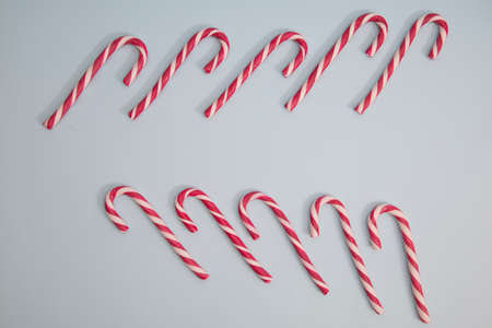 red and white christmas candy cane, on a blue background.の写真素材