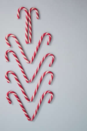 red and white christmas candy cane, on a blue background.
