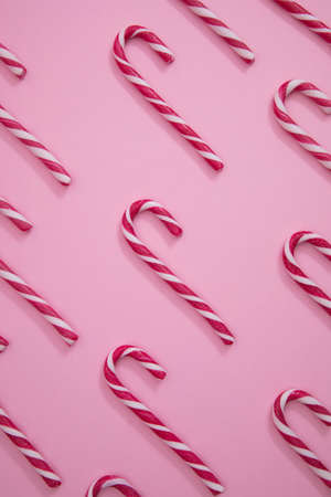 red and white christmas candy cane, on a blue background.の写真素材