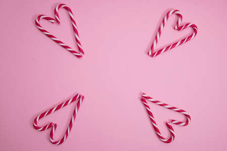 red and white christmas candy cane, on a blue background.の写真素材