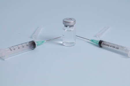 COVID vaccine, Coronavirus vaccine difference dose and size with needle, prepare for injection, medical vaccine on a blude background.の写真素材