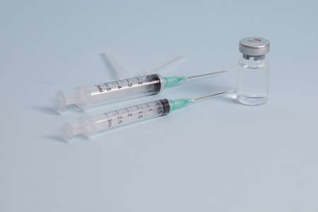 COVID vaccine, Coronavirus vaccine difference dose and size with needle, prepare for injection, medical vaccine on a blude background.の写真素材