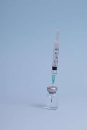 COVID vaccine, Coronavirus vaccine difference dose and size with needle, prepare for injection, medical vaccine on a blude background.の写真素材