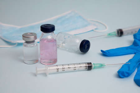 COVID vaccine, Coronavirus vaccine difference dose and size with needle, prepare for injection, medical vaccine on a blude background.の写真素材