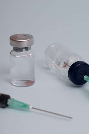 COVID vaccine, Coronavirus vaccine difference dose and size with needle, prepare for injection, medical vaccine on a blude background.の写真素材