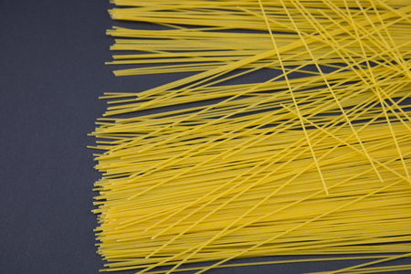 top view of raw Italian spaghetti isolated on black, panoramic shot.の写真素材