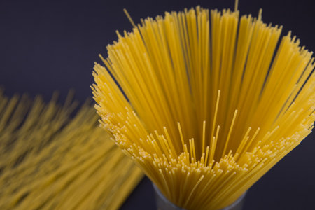 top view of raw Italian spaghetti isolated on black, panoramic shot.の写真素材