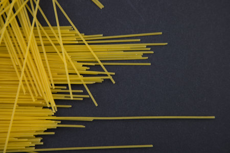 top view of raw Italian spaghetti isolated on black, panoramic shot.の写真素材