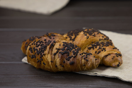 tasty croissants with chocolate on wooden backgroundの写真素材