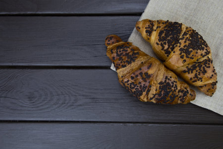 tasty croissants with chocolate on wooden backgroundの写真素材
