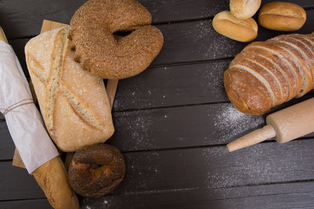 Homemade crusty bread cooking on blackboard background. Top view with space for your textの写真素材