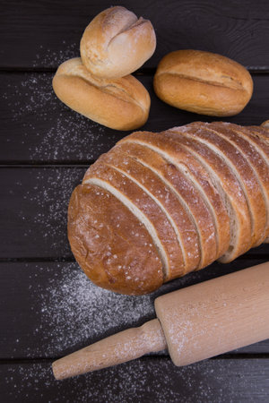 Homemade crusty bread cooking on blackboard background. Top view with space for your textの写真素材