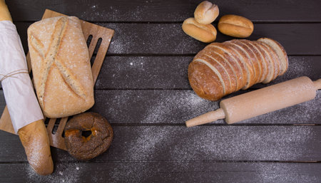 Homemade crusty bread cooking on blackboard background. Top view with space for your textの写真素材