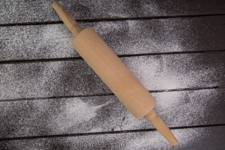 Baking background with free space for your text. Rolling pin and flour on black table. Copy space. Top viewの写真素材