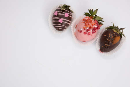 Assorted strawberries in chocolate, sweet dessert, berries in different chocolate and sprinkled with...