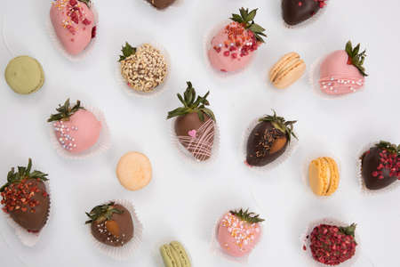 Variety of strawberries covered with chocolate, dark and white chocolate and nuts.の写真素材