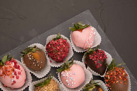 Assorted strawberries in chocolate with macaron, sweet dessert, free space for your text, sprinkled with nuts, top view, isolated background.の写真素材