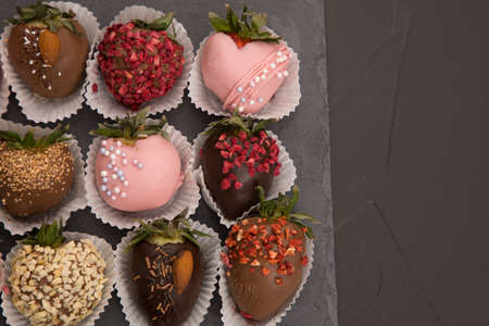 Assorted strawberries in chocolate with macaron, sweet dessert, free space for your text, sprinkled with nuts, top view, isolated background.の写真素材