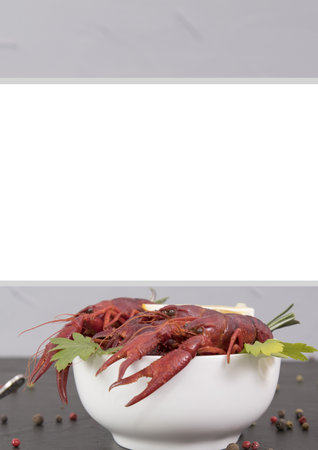 Delicious boiled crayfish close-up on a stone plate with lemon and parsley.の写真素材
