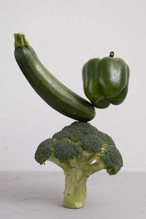 Fresh green vegetables on the table. zucchini, pepper and broccoli Floating food balance concept, levitation.の写真素材